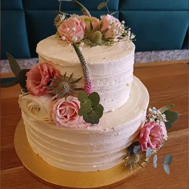 Zweistöckige Hochzeitstorte mit rosa Rosen, Lisianthus und Disteln aus der Konditorei in Jena