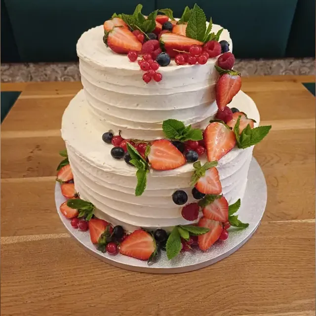 Zweistöckige Sahnetorte mit frischen Erdbeeren und Beeren vom Café am Markt in Jena